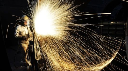 A Chinese worker cutting steel in Qingdao in China's eastern Shandong province. A Chinese worker cutting steel in Qingdao in China's eastern Shandong province.